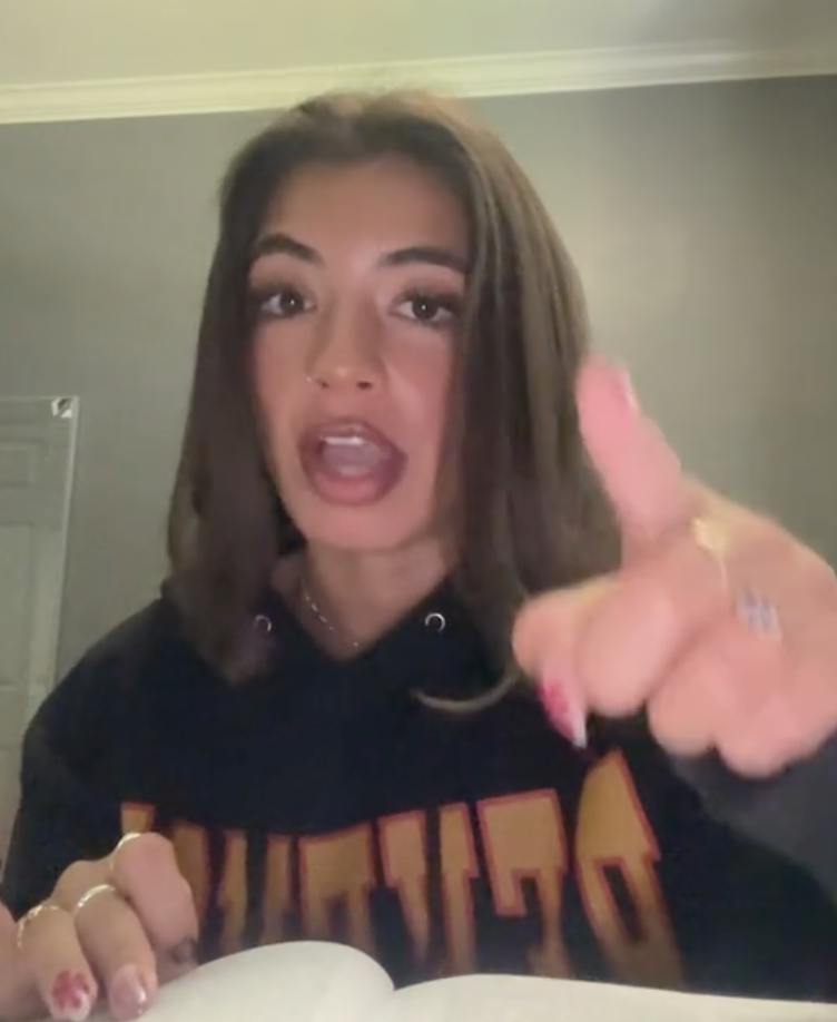 woman pointing at a camera